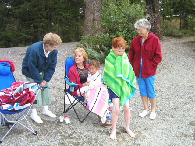 Thema McLain and Ann LaCroix visit with family members who have just returned from a dip in the lake.