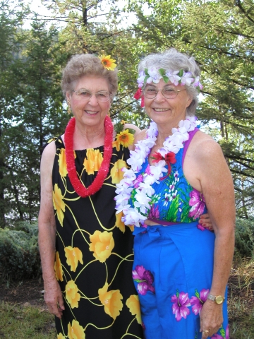 Thelma McLain and Ann LaCroix dress up for the Hawaiian celebration.