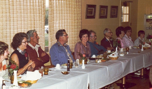 Wilford Cole and his children enjoy visiting at the head table.